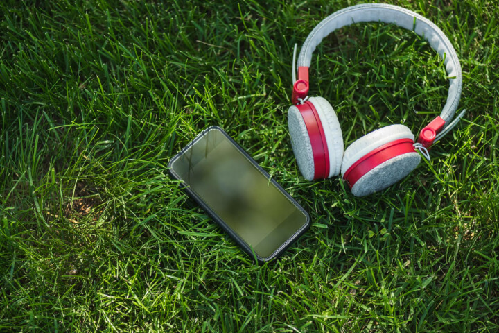 Headphones Brand Names: a phone and headphones placed on the ground