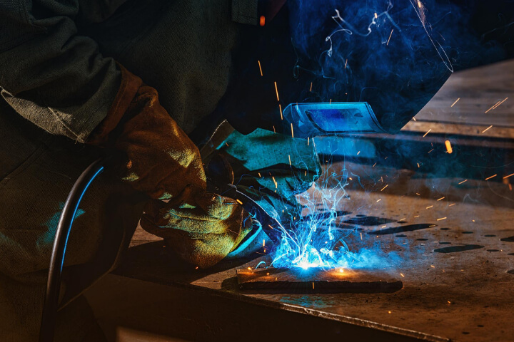 Welding Business Names: a man is welding an iron